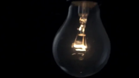Light bulb swinging to camera. Slow motion. Stock Footage 72604114