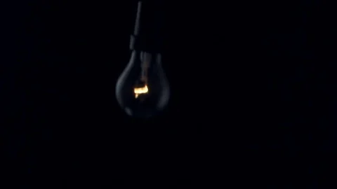 Light bulb swinging to camera. Slow motion. Stock Footage 72606579