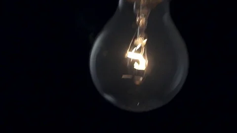 Light bulb swinging to camera. Slow motion. Stock Footage 72606782
