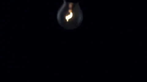 Light bulb swinging to camera. Slow motion. Stock Footage 72606983