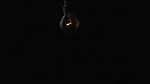 Light bulb swinging to camera. Slow motion. Stock Footage 72607567