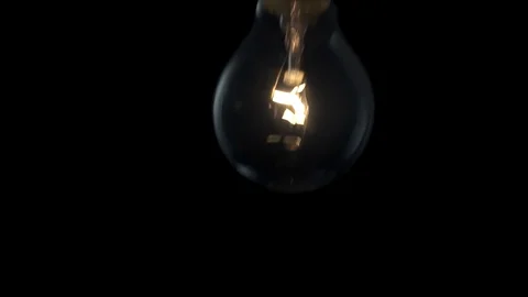 Light bulb swinging to camera in slow motion. 4k Black background Stock Footage 89648943