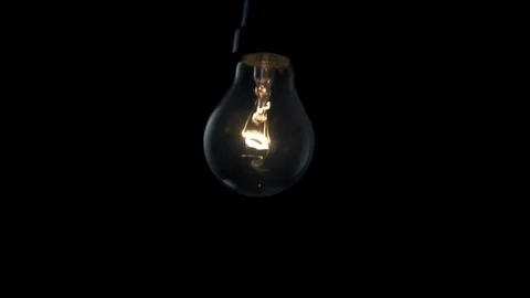 Light bulb swinging in slow motion. 4k Black background Stock Footage 89648880