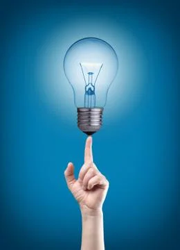 Light bulb on tip of finger Stock Photos