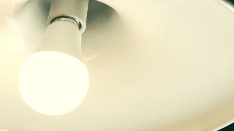Light Bulb Turned On by Twisting Stock Footage 146759666
