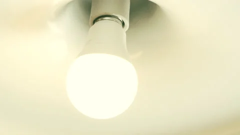 Light Bulb Turned On by Twisting Stock Footage 146784789