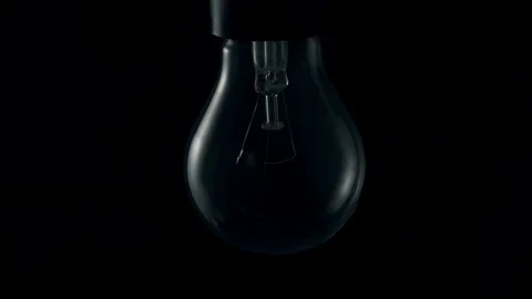 Light bulb turning on. 4k Stock Footage 89648988