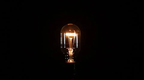 Light bulb turns on and off fast and slow on black background (medium shot) Video stock 51606716
