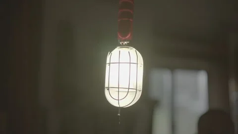 Light bulb turns on in dark garage or shed Stock Footage 323475873