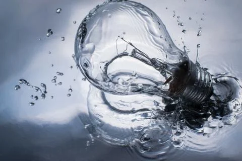 Light bulb with water splash knowledge background concept. Stock Photos