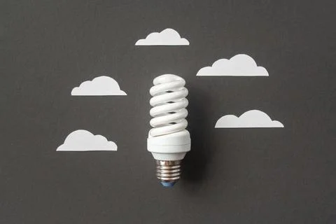 Light bulb with white cut out clouds. Idea concept Stock Photos