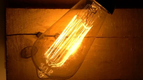 Light bulb on a wooden background Stock Footage 83943560