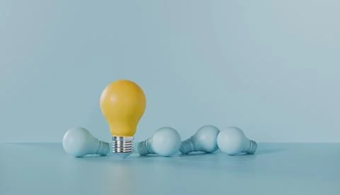 Light bulb yellow outstanding among lightbulb light blue on color background Stock Photos