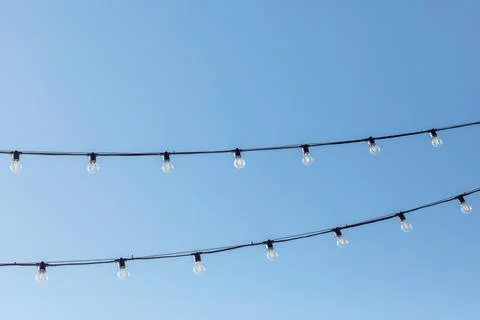 Light bulbs on the background of a clear sky Stock Photos