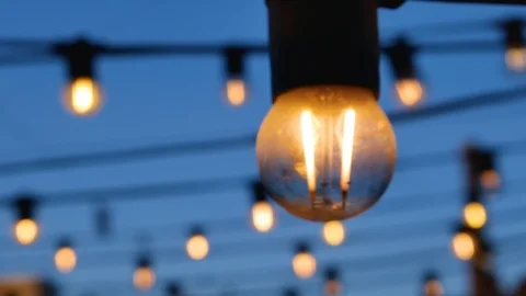 Light bulbs on the background of wires and blue sky. Stock Footage 125467602