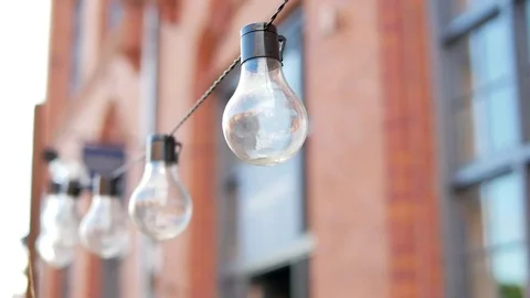 Light Bulbs on the Blurred Red Brick Background in Liverpool, United Kingdom Stock Footage 83499682