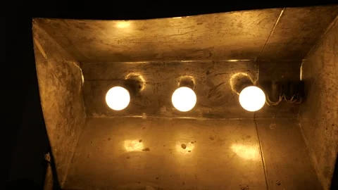 Light bulbs consequently lit in the old reflective lamp Stock Footage 289547757