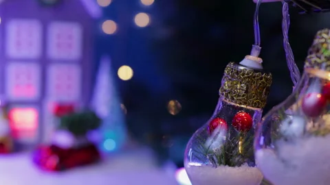 Light bulbs decorated in the middle against a blurred background of a gray house Stock Footage 326850094