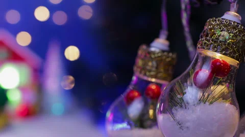 Light bulbs decorated in the middle against a blurred background of a red house Stock Footage 326850095