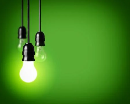 Light bulbs on green background Stock Photos
