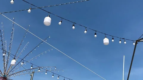 Off Light Bulbs Hanging On Electric Lines On Blue Sky Background Stock Footage 299805317