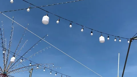 Off Light Bulbs Hanging On Electric Lines With Birds Flying On Blue Sky Stock Footage 299805327
