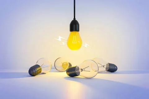 Light bulbs with one glowing yellow bulb hanging above Stock Photos