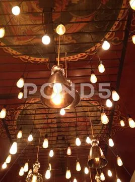 Light bulbs suspended from ceiling Stock Photos