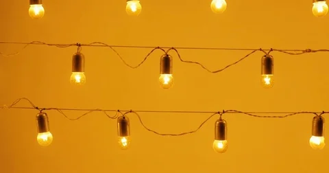 Light bulbs on a wire against wall, holiday concept, light bulbs orange, lamp Stock Footage 80282167