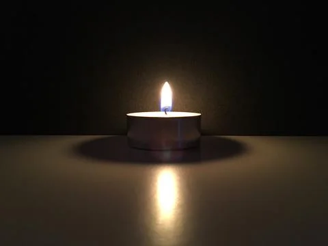 The light of a burning candle in the darkness Stock Photos