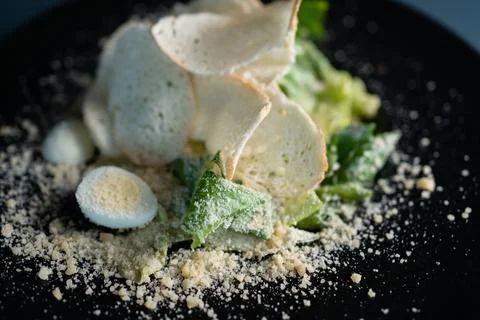 Light caesar salad without meat on black plate on dark background Foto stock