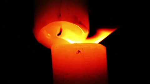 Light a candle with another candle; candlelight in the dark Stock Footage 35530767