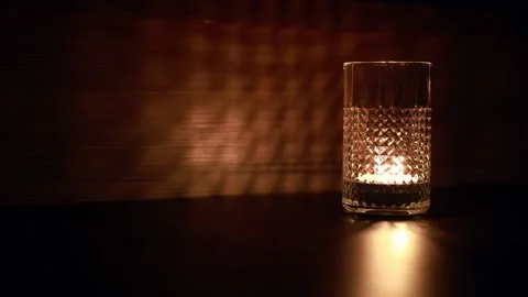 The light of a candle in a candlestick is reflected on the wall. Stock Footage 214337476