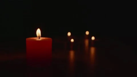 Light a candle in the dark, the flame warms and the light creates bokeh. Ligh Stock Footage 188427191