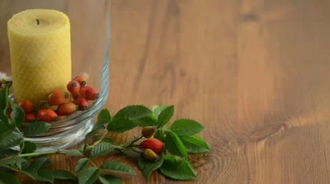 To light a candle in glass with rose hips. Stock Footage