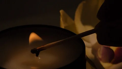 Light candle by match, close up of burning scented soy candle Stock Footage 126624251