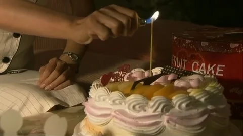 Light the candles on the cake Stock Footage 253773914