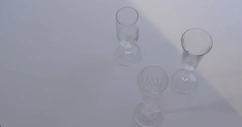 Light changing modifying shadow of champagne flutes Stock Footage 142956425