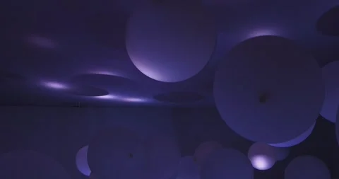 Light changing on white balloons attached to ceiling Stock Footage 300617628