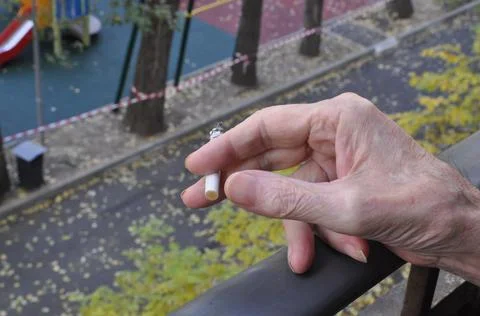 A light cigarette in the hand of a human Stock Photos
