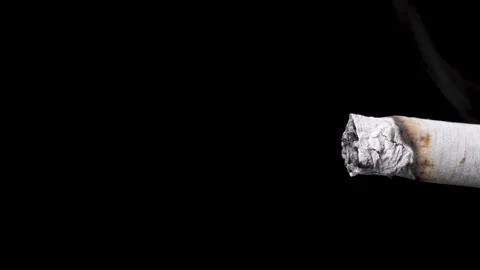 Light a cigarette with lighter, macro, time-lapse shot, black background. Stock Footage 147075148