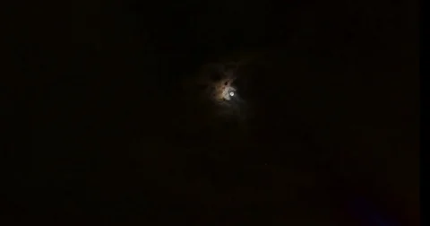 Light circle of moon with passing clouds - time lapse 4K DCI Stock Footage 80799729