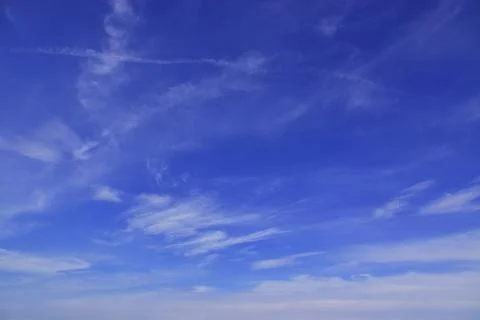 Light cirrus clouds in the blue sky. A fine summer in the Western Urals. Stock Photos