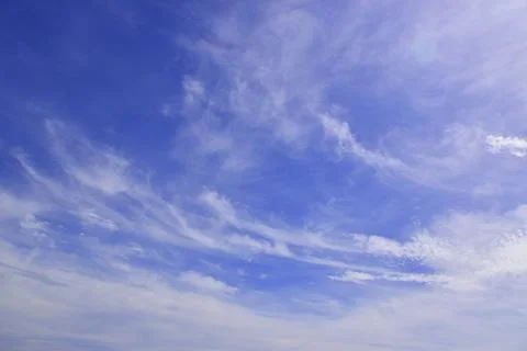 Light cirrus clouds in the blue sky. A fine summer in the Western Urals. Stock Photos