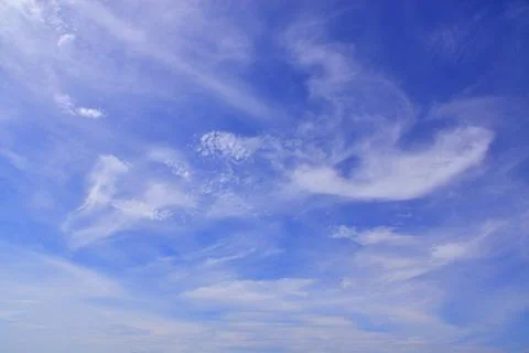 Light cirrus clouds in the blue sky. A fine summer in the Western Urals. Stock Photos