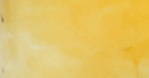Light cloudy liquid has a dark orange paint poured into it Stock Footage 114086430