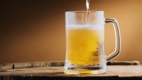 Light cold beer is poured into a beer glass Stock Footage 125638273