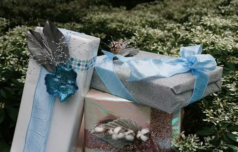 Light color boxes of wrapped presents underneath a Christmas tree Stock Photos