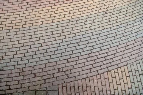 Light colored brick pavement forming a repeating pattern on a walkway surface Stock Photos