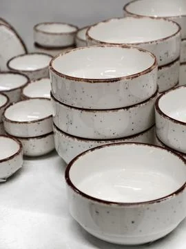 Light colored ceramic deep plates arranged in stacks creating basic tablewa.. Stock Photos